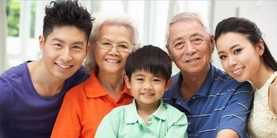 A multi-generational family smiling together