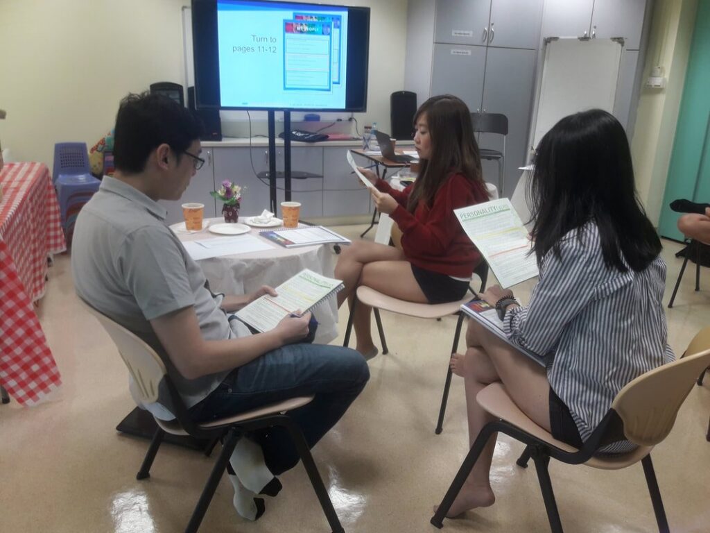 Couples working through Prepare & Enrich worksheets in a Careworks session